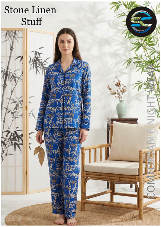 Woman wearing a blue patterned pajama set in a room with a chair and plants.