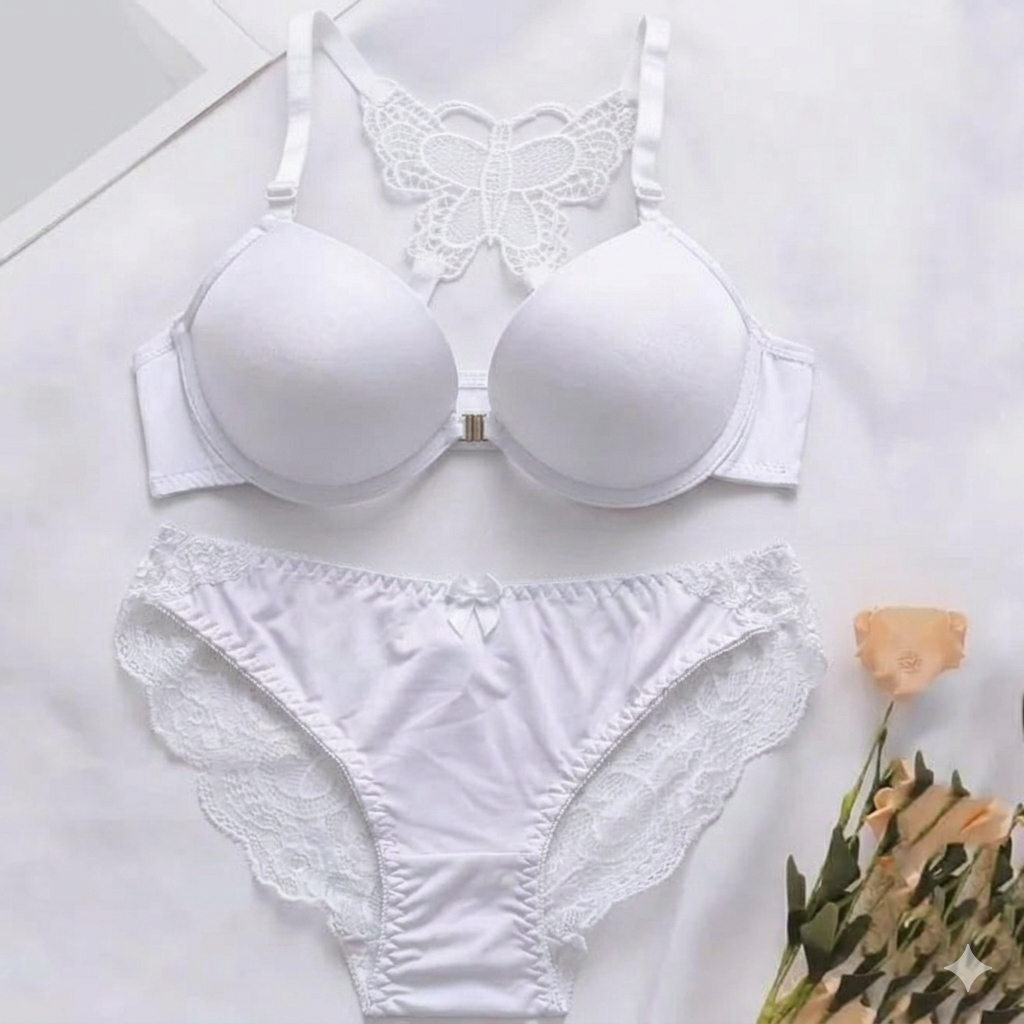 White bra and panties set on a light background with a flower.