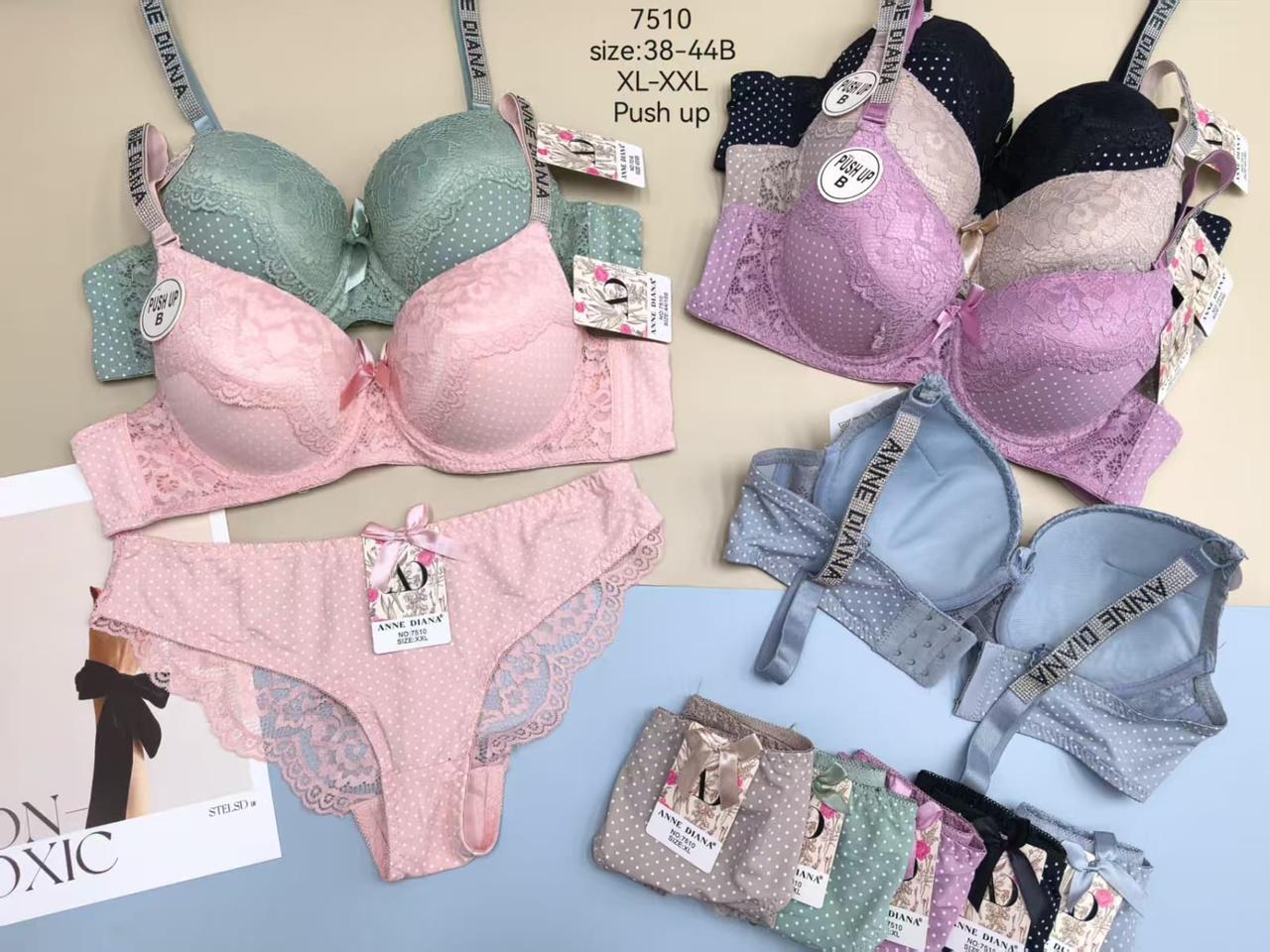 Collection of Anne Cole bras and panties on a table with a magazine underneath.