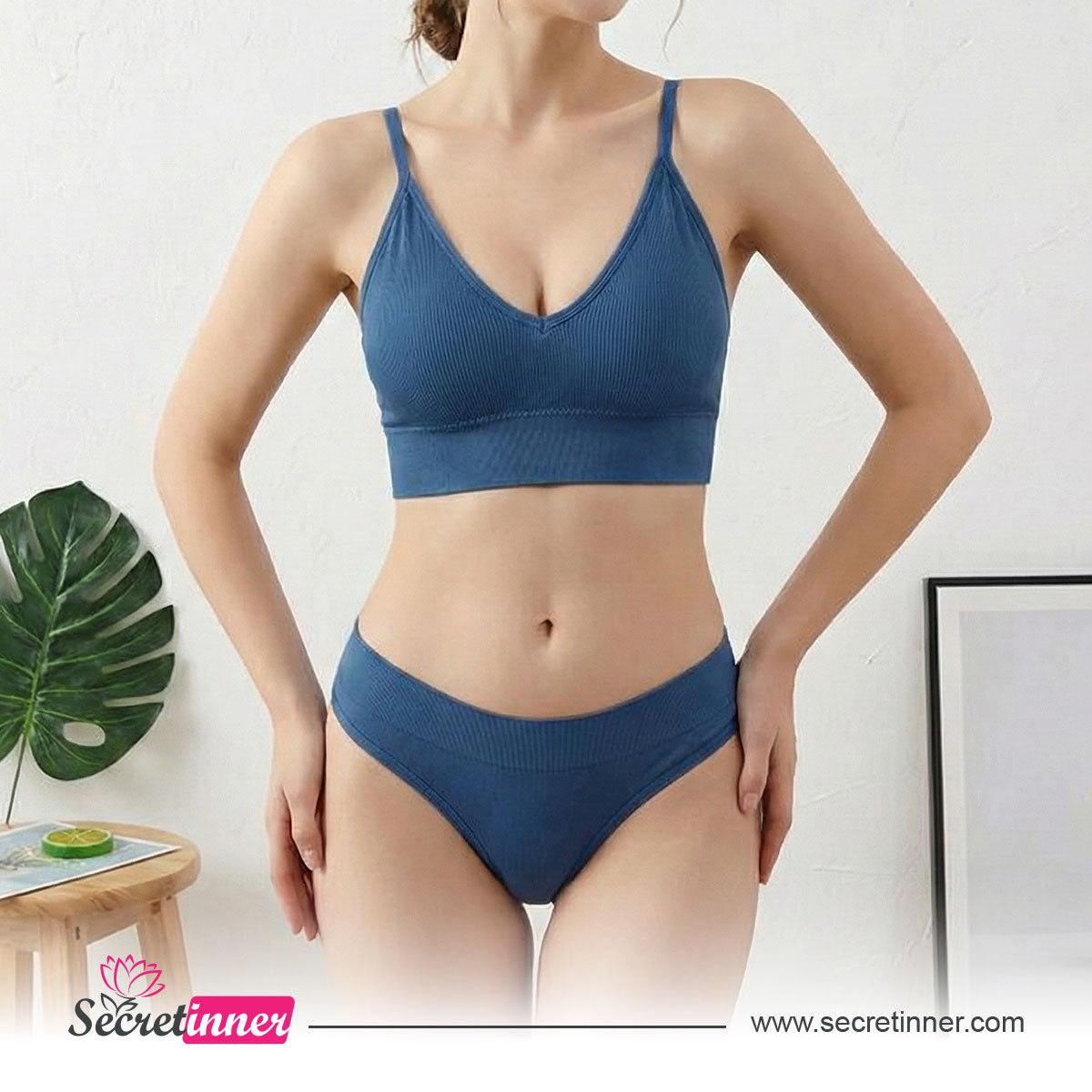 Woman wearing a blue bikini set with a white background and Secret Inner logo.