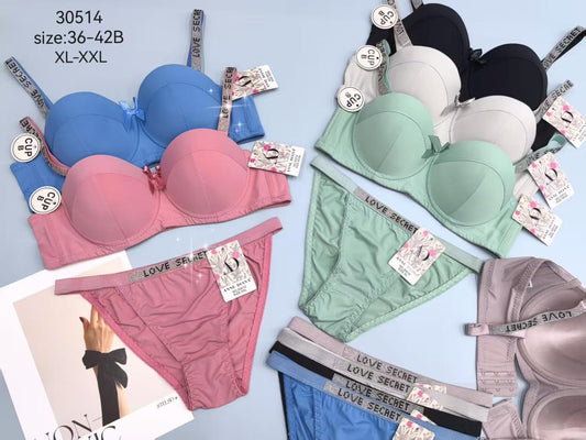 Collection of Love Secret bras and panties on a light blue background