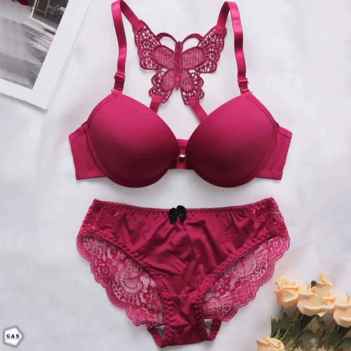 Red lingerie set with butterfly design on a white background