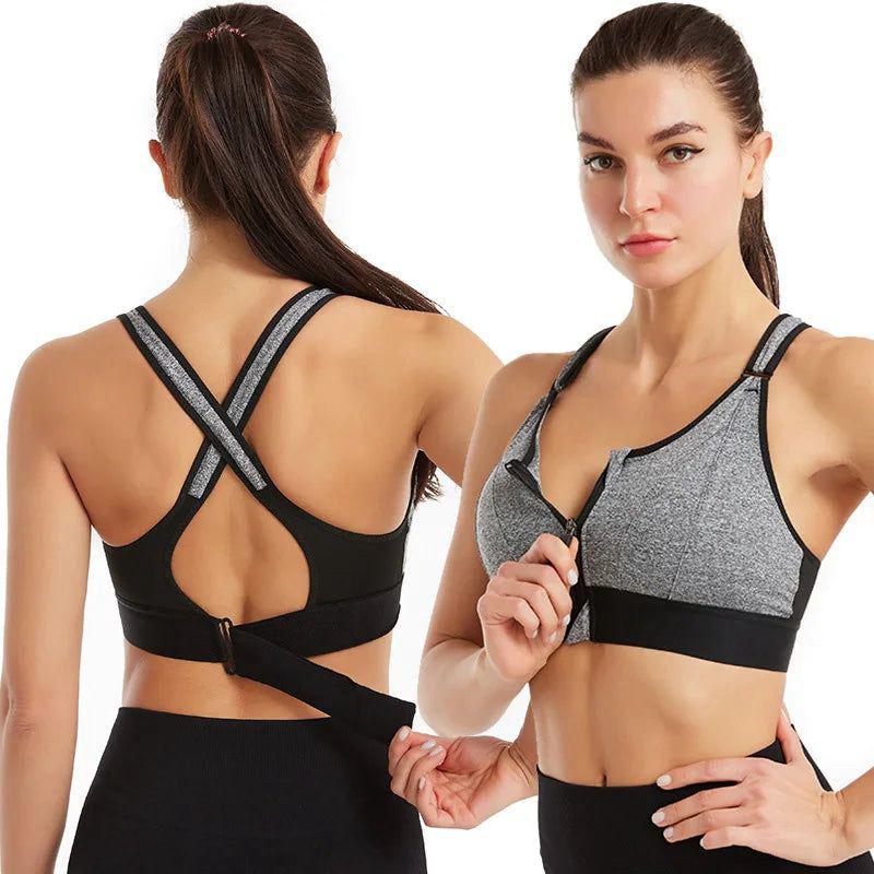 Woman wearing a gray and black sports bra with a plain background