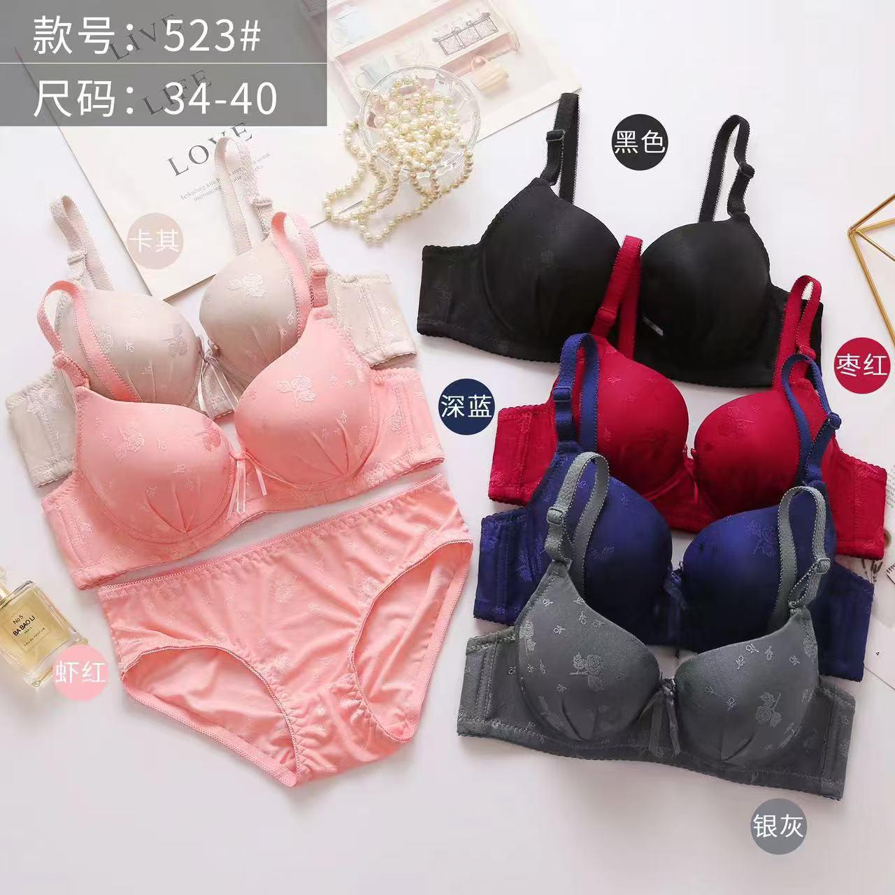 Collection of bras and panties in various colors on a white background
