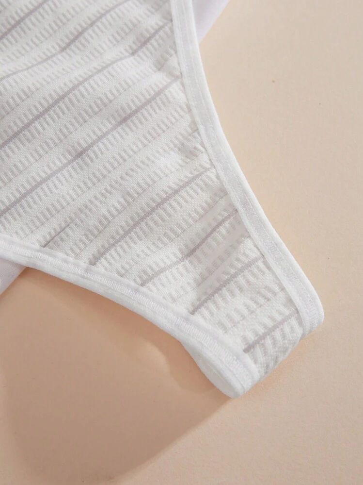 Close-up of a white bra on a beige background