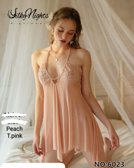 Woman wearing a peach lace nightgown with 'Silky Nights' branding.