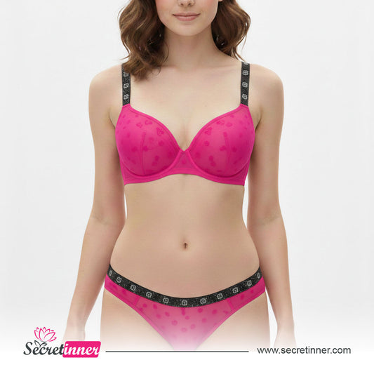 Woman wearing a pink bra and panties set with 'Secret Inner' branding on a white background.