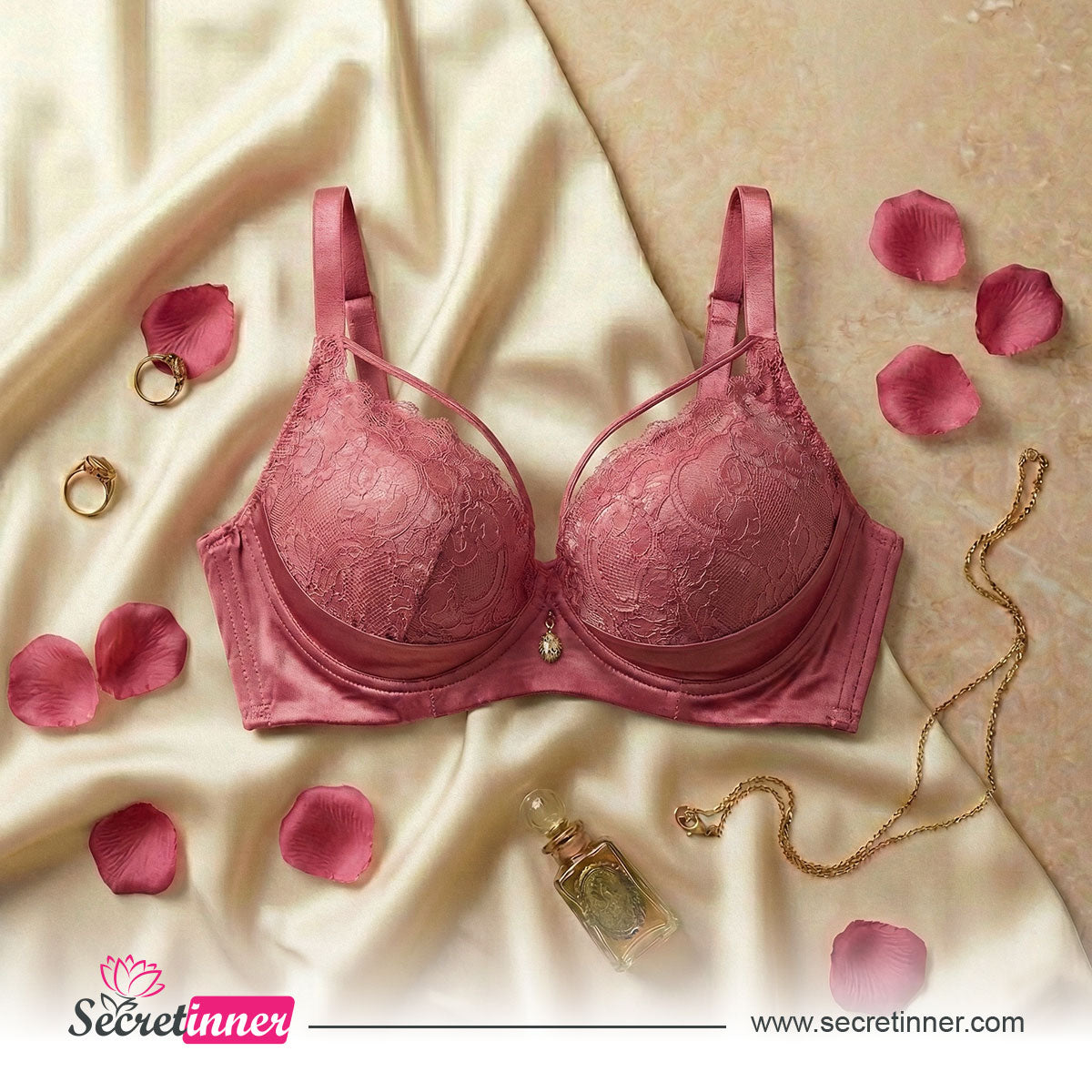 Pink bra on a beige fabric background with rose petals and jewelry, Secretinner brand visible.