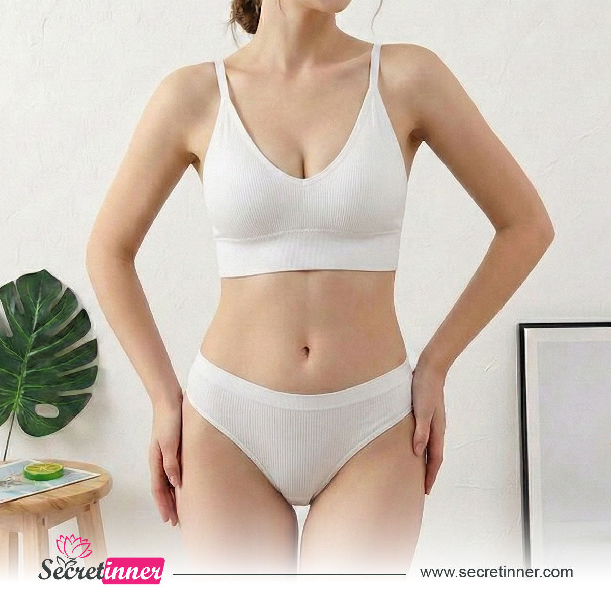 Woman wearing a white bra and panties set with a minimal background
