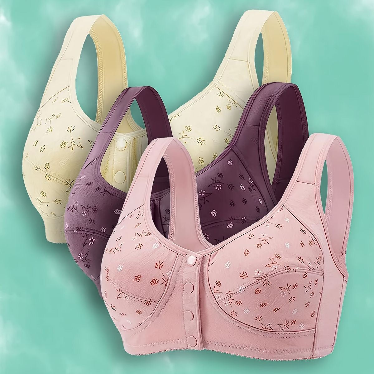 Three bras in different colors on a teal background